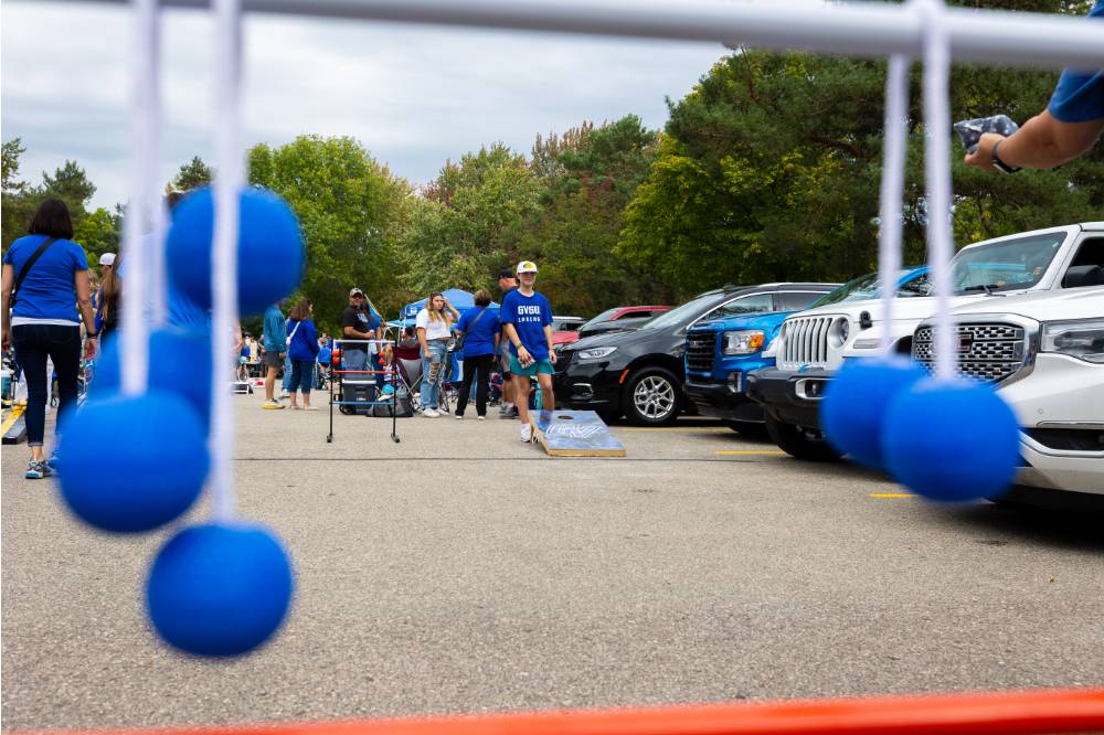 Attendee plays ladder ball game during Family Day tailgate.